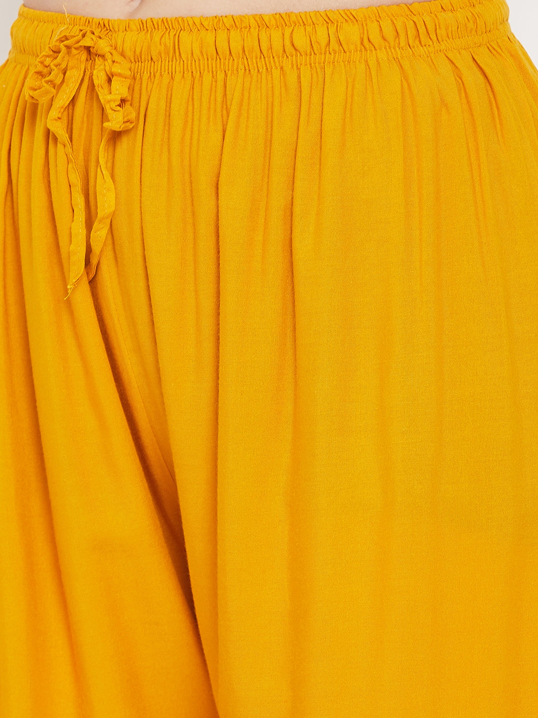Mustard printed rayon palazzo with elastic waistband.