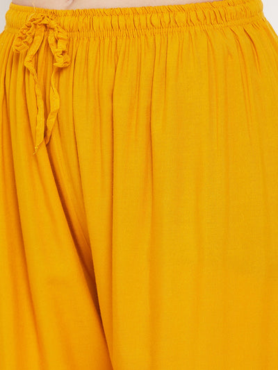 Mustard printed rayon palazzo with elastic waistband.