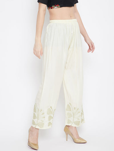 Cream Hem Design Straight Palazzo in rayon fabric with floral accents on the hem, worn with beige heels.