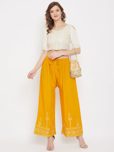 Mustard wide leg hem design palazzo in lightweight rayon fabric.