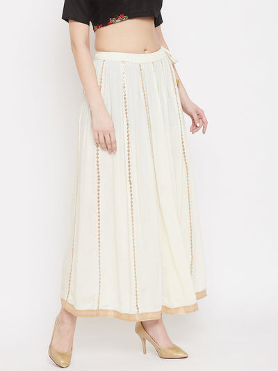 Cream Gotta Patti flared skirt in Rayon fabric, paired with heels.