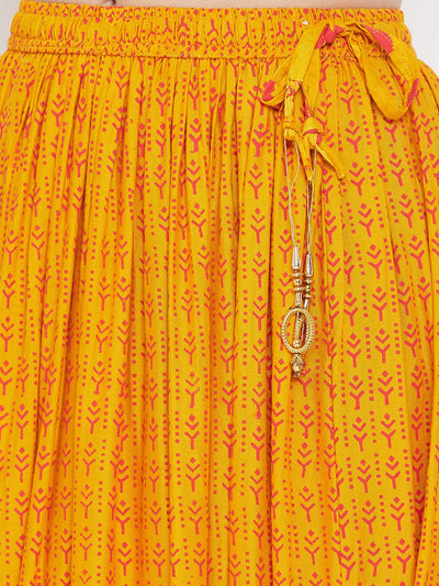 Mustard printed rayon flared skirt with decorative tassels.