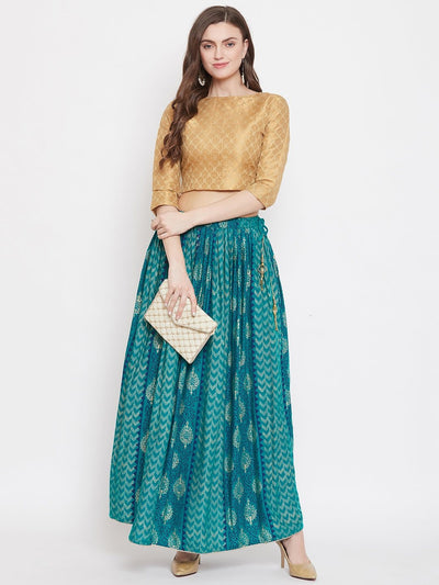 Turquoise printed rayon maxi skirt with flared design, styled with a blouse and high heels.