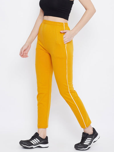 Mustard straight fit trackpants for women made from lightweight hosiery fabric.