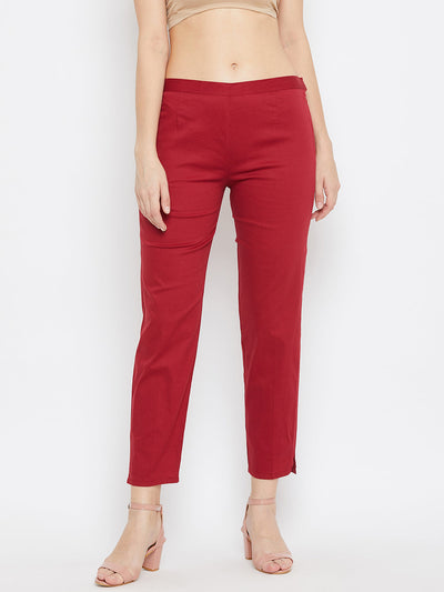 Maroon regular fit solid pants for women made of lightweight cotton fabric.