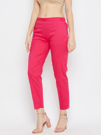 Magenta regular fit solid pants for women made from lightweight cotton fabric.