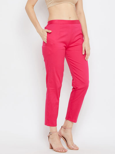 Magenta regular fit solid pants for women made from comfortable cotton fabric.