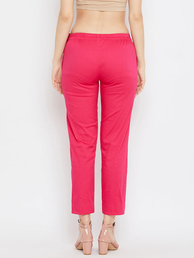 Magenta regular fit solid pants for women by Baani.