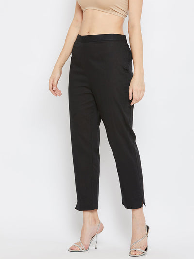 Black regular fit solid pants for women made from cotton fabric.