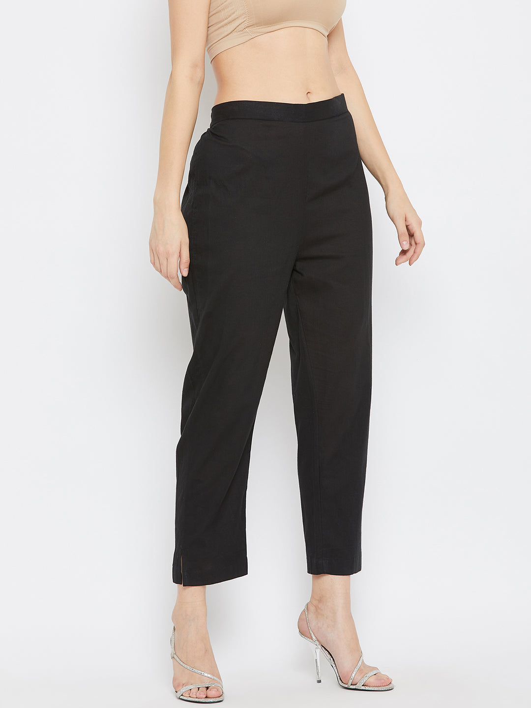 Black regular fit solid pants for women made from lightweight cotton fabric.