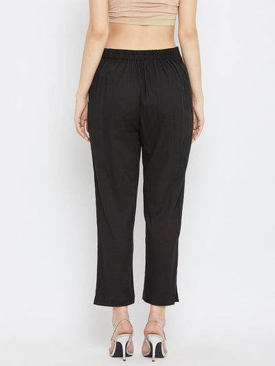 Black regular fit solid pants for women made from comfortable cotton fabric.