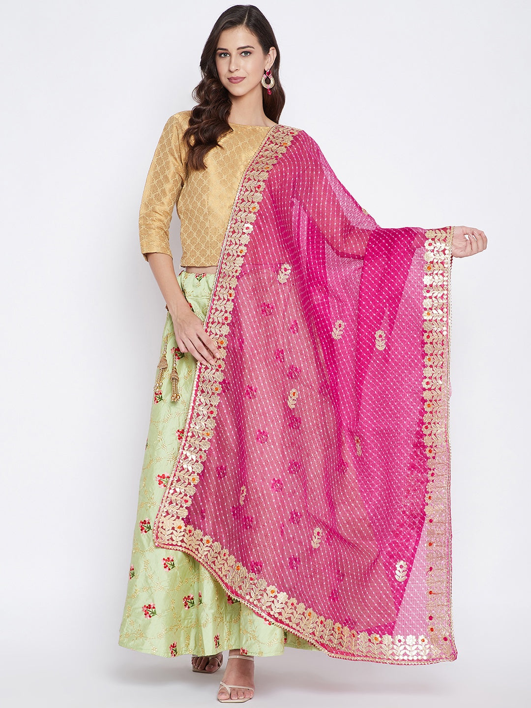 Magenta Bandhej dyed dupatta styled with ethnic wear.