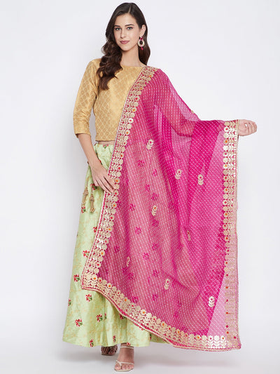 Magenta Bandhej dyed dupatta styled with ethnic wear.