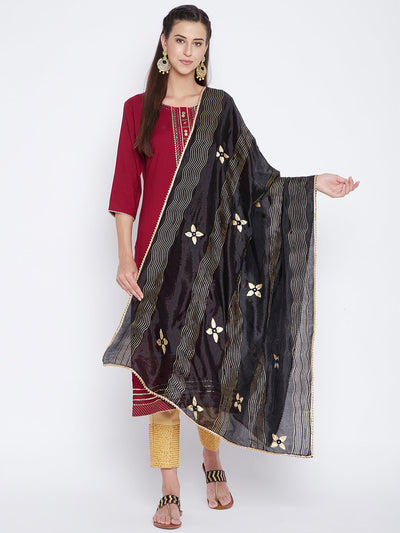 Black printed silk dupatta with floral design styled over traditional attire.