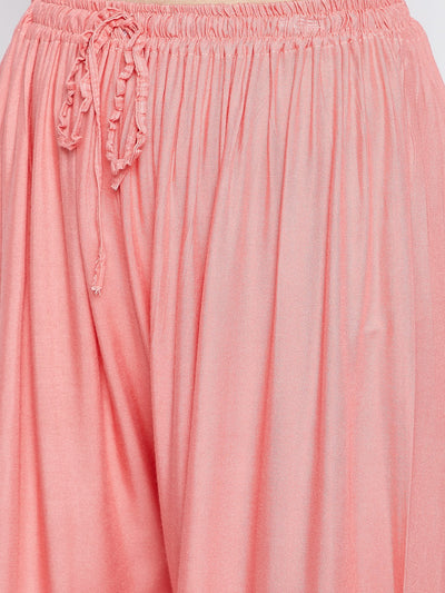 Peach solid rayon palazzo with drawstring waist detailing.