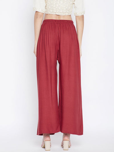 Rust solid rayon palazzo pants with elastic waistband.