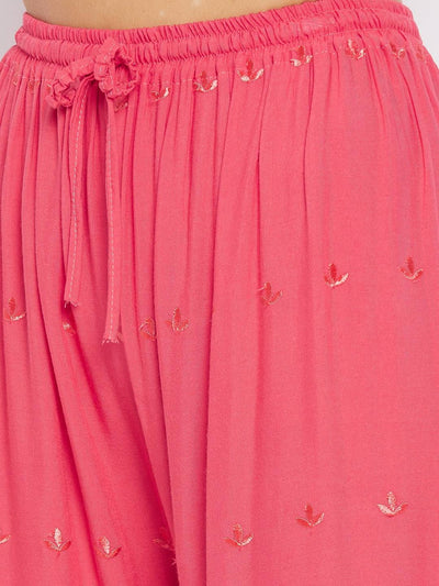 Peach solid rayon palazzo with chikankari embroidery detailing.