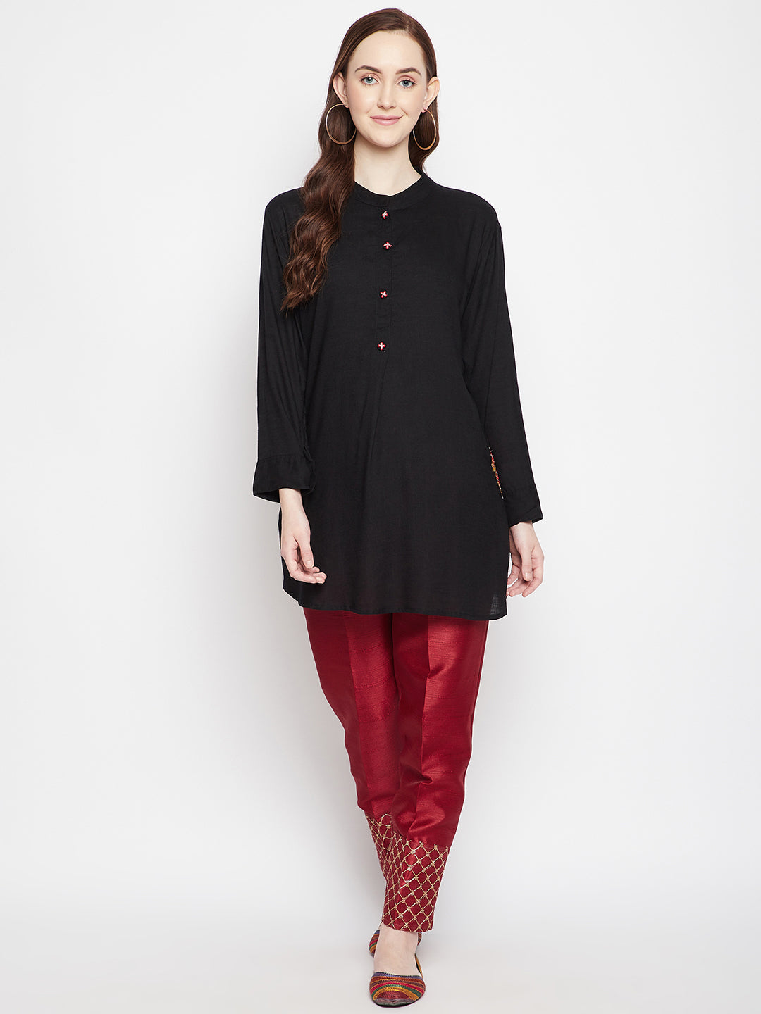 Maroon hem design silk trouser with embellished hem, paired with a black top.