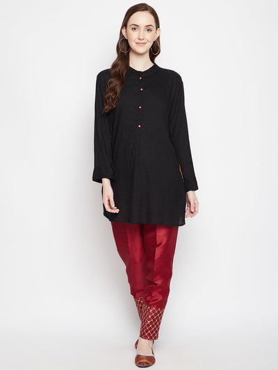 Maroon hem design silk trouser with embellished hem, paired with a black top.