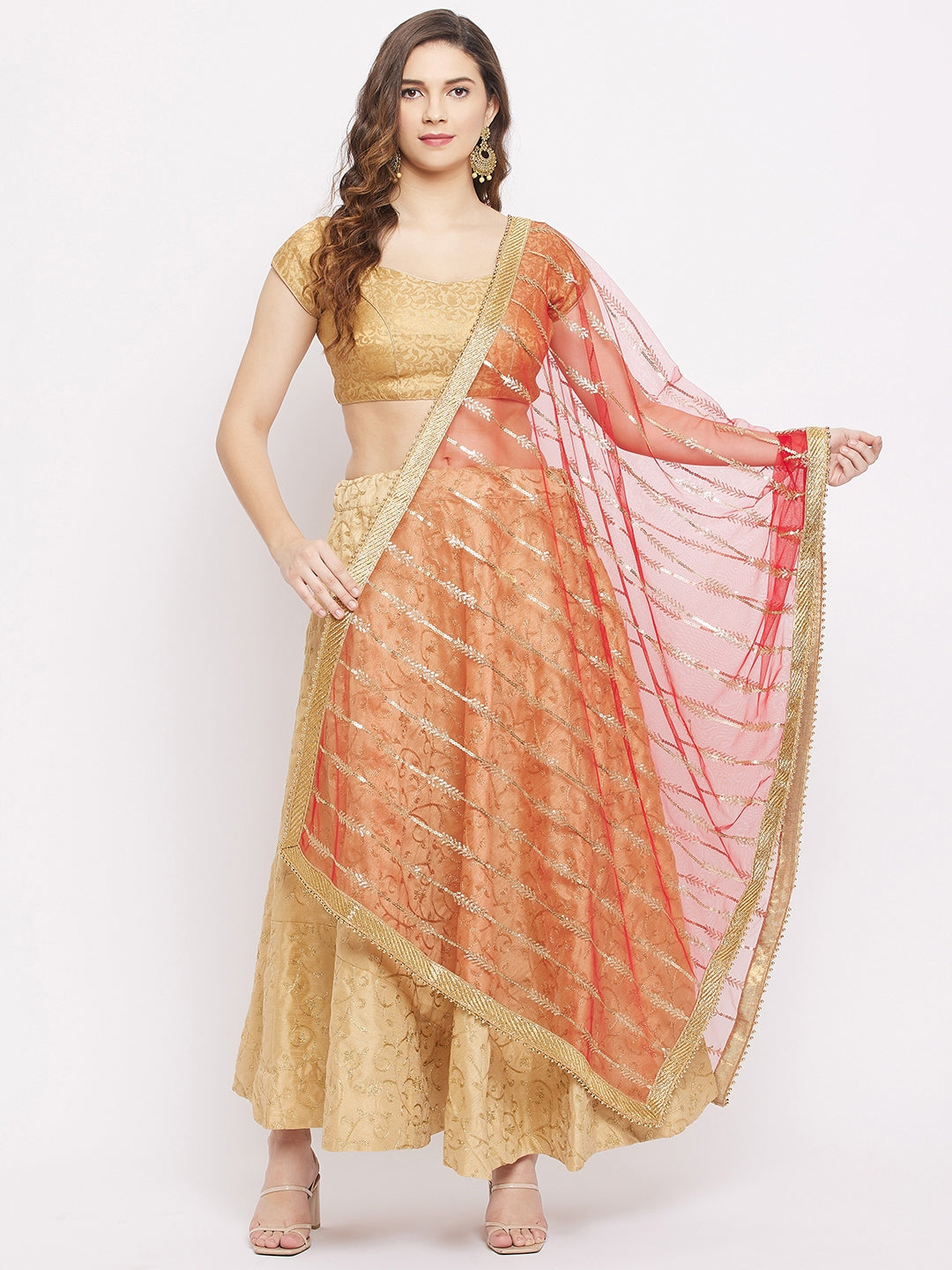 Red sequined net dupatta paired with a gold kurta set.