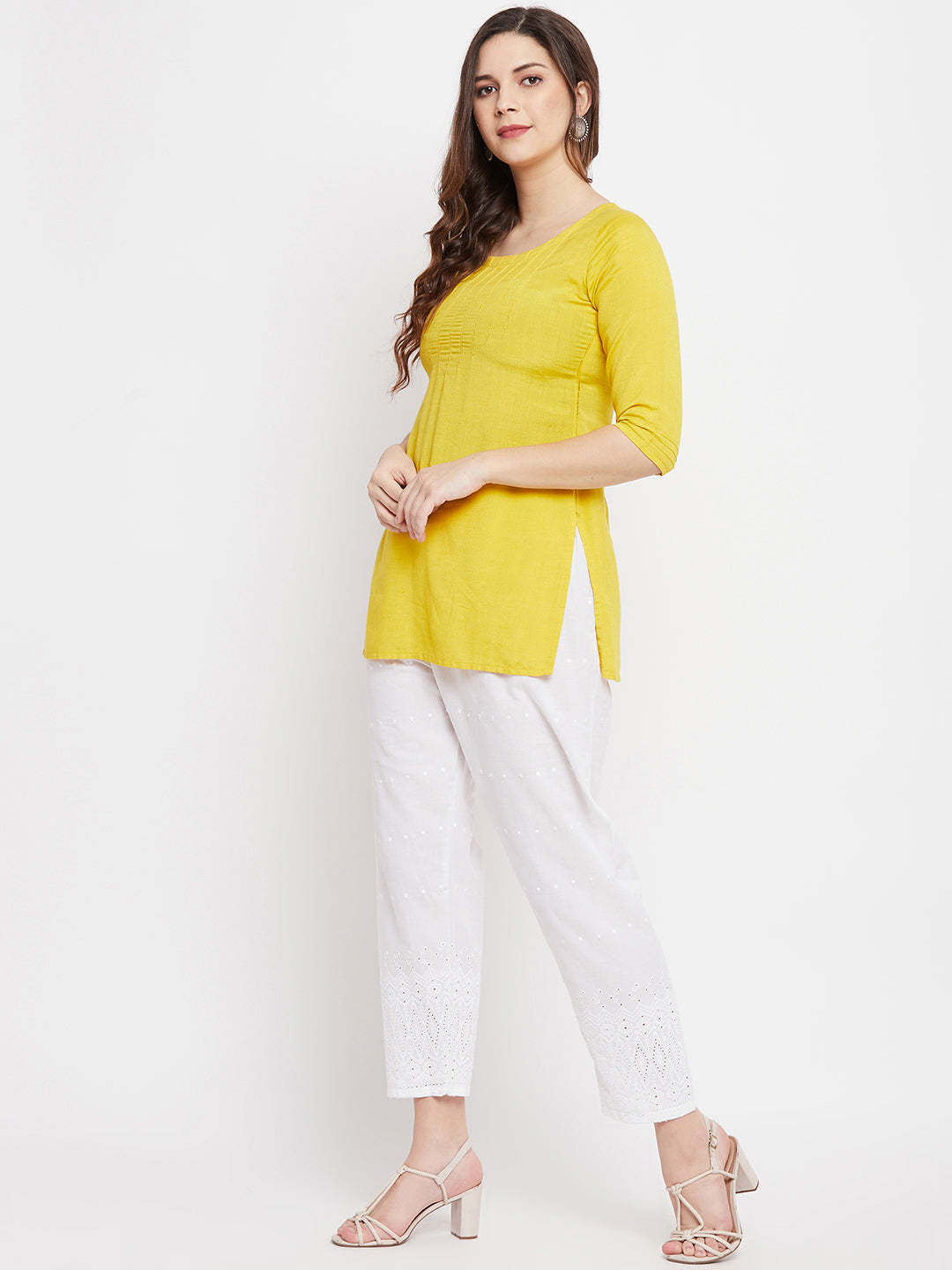 White Chikankari Cotton Palazzo with elasticated waistband, paired with a yellow kurta and high heels.