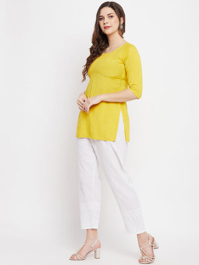 White Chikankari Cotton Palazzo with elasticated waistband, paired with a yellow kurta and high heels.