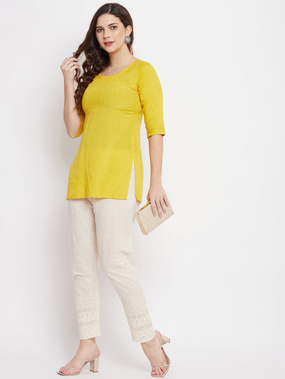 Cream Chikankari Cotton Palazzo with elastic waistband paired with yellow kurta and heels.