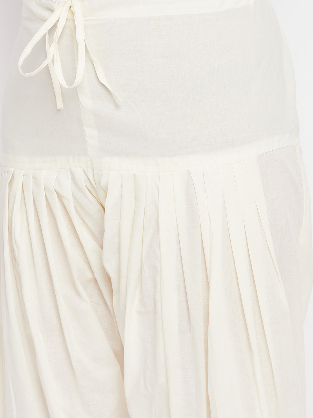 Cream solid pure cotton salwar with pleated design.