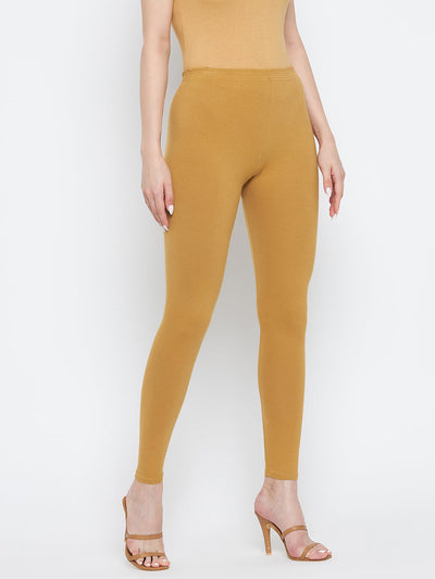 Fawn solid ankle length leggings made from cotton lycra, styled with high heels.