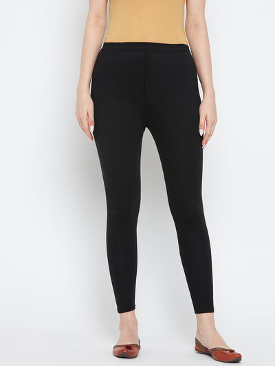 Black solid ankle length leggings made from premium cotton lycra fabric, ideal for pairing with a Kurta and high heels.