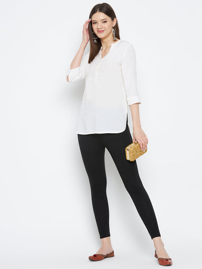 Black solid ankle length leggings made of premium cotton lycra fabric.