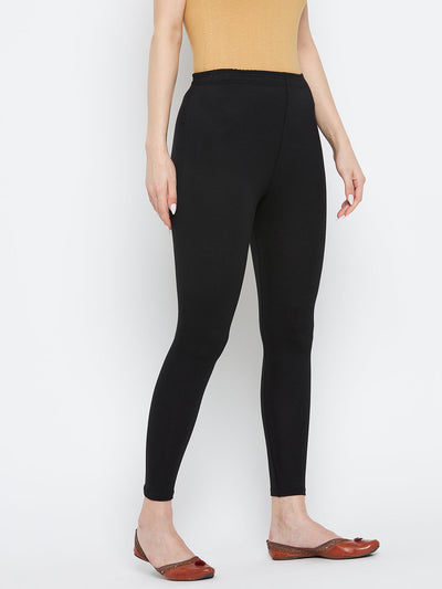 Black solid ankle length leggings made from cotton lycra fabric.
