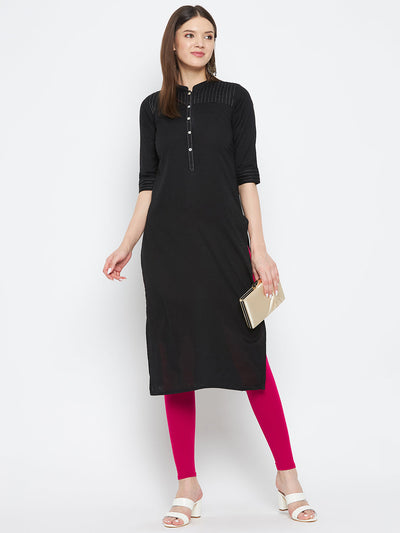 Magenta solid ankle length leggings paired with a black kurta.