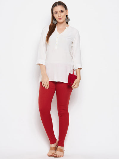 Red solid woolen leggings paired with a white kurta and heels.