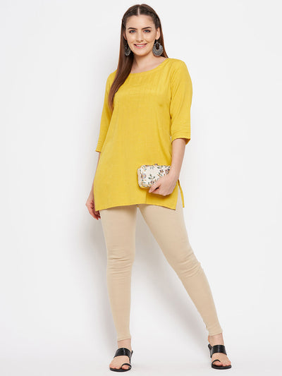 Light fawn solid woolen leggings paired with a yellow kurta.