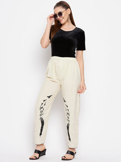 Beige embroidered trouser with elastic waistband.