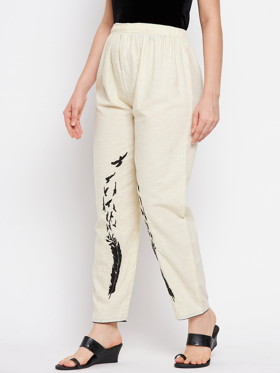 Beige embroidered trouser with bird design, elasticated waistband.