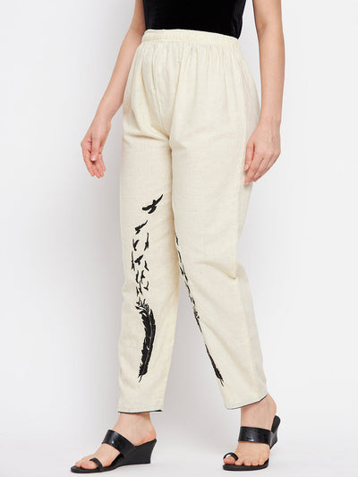 Beige embroidered trouser with bird design, elasticated waistband.