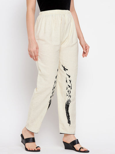 Beige embroidered trouser with black design on leg, elasticated waistband, made from fine cotton fabric.