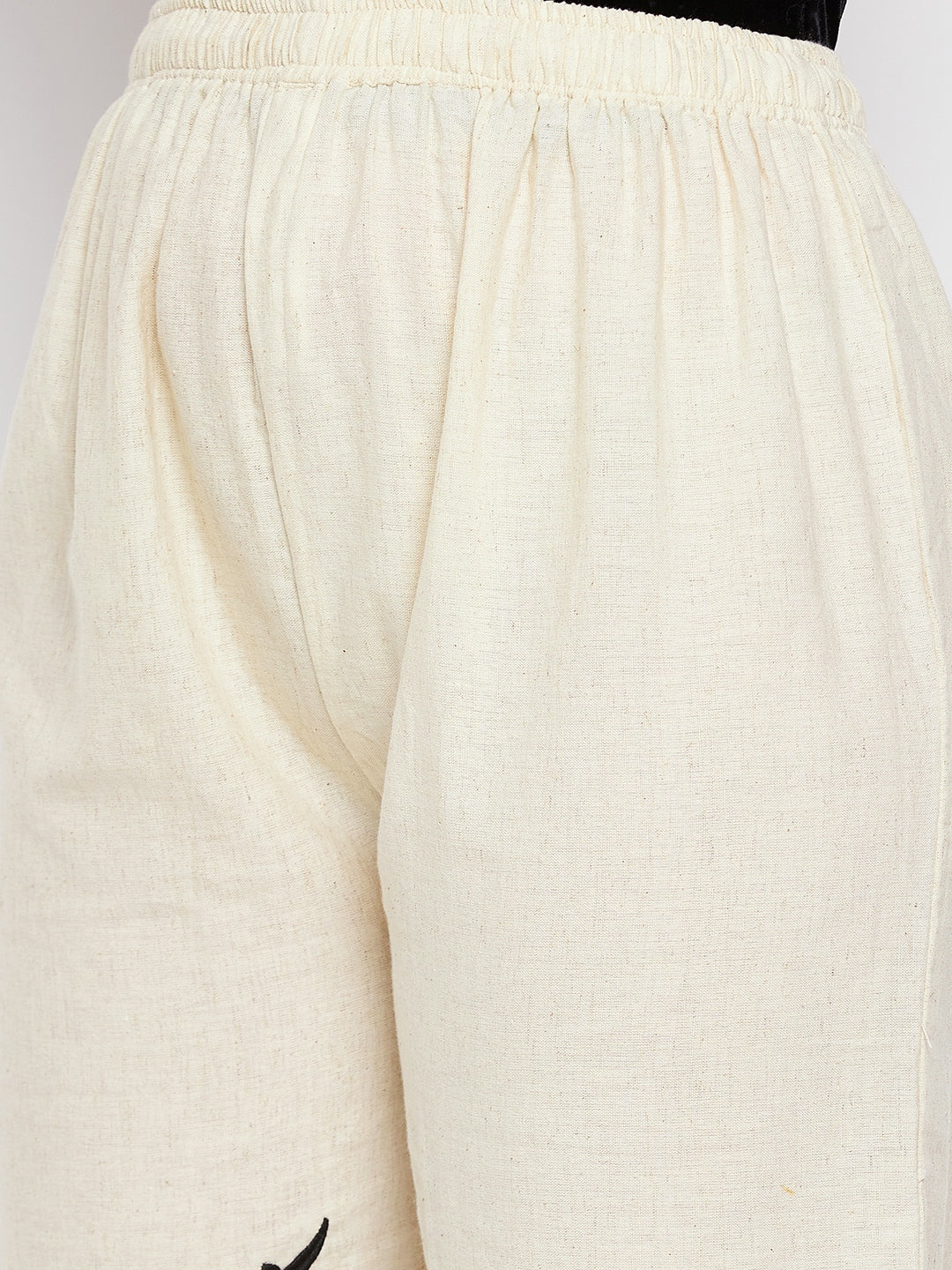 Beige embroidered trouser with elastic waistband and cotton fabric.