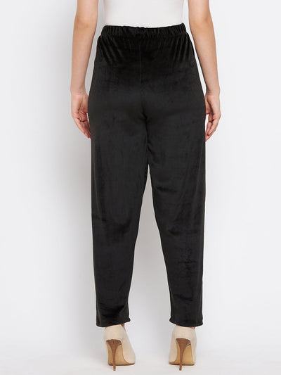 Black velvet palazzo pants from Clora, featuring a solid design, perfect for a summer casual wardrobe.