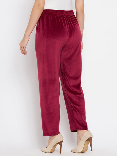 Maroon solid velvet palazzo paired with beige high heels.