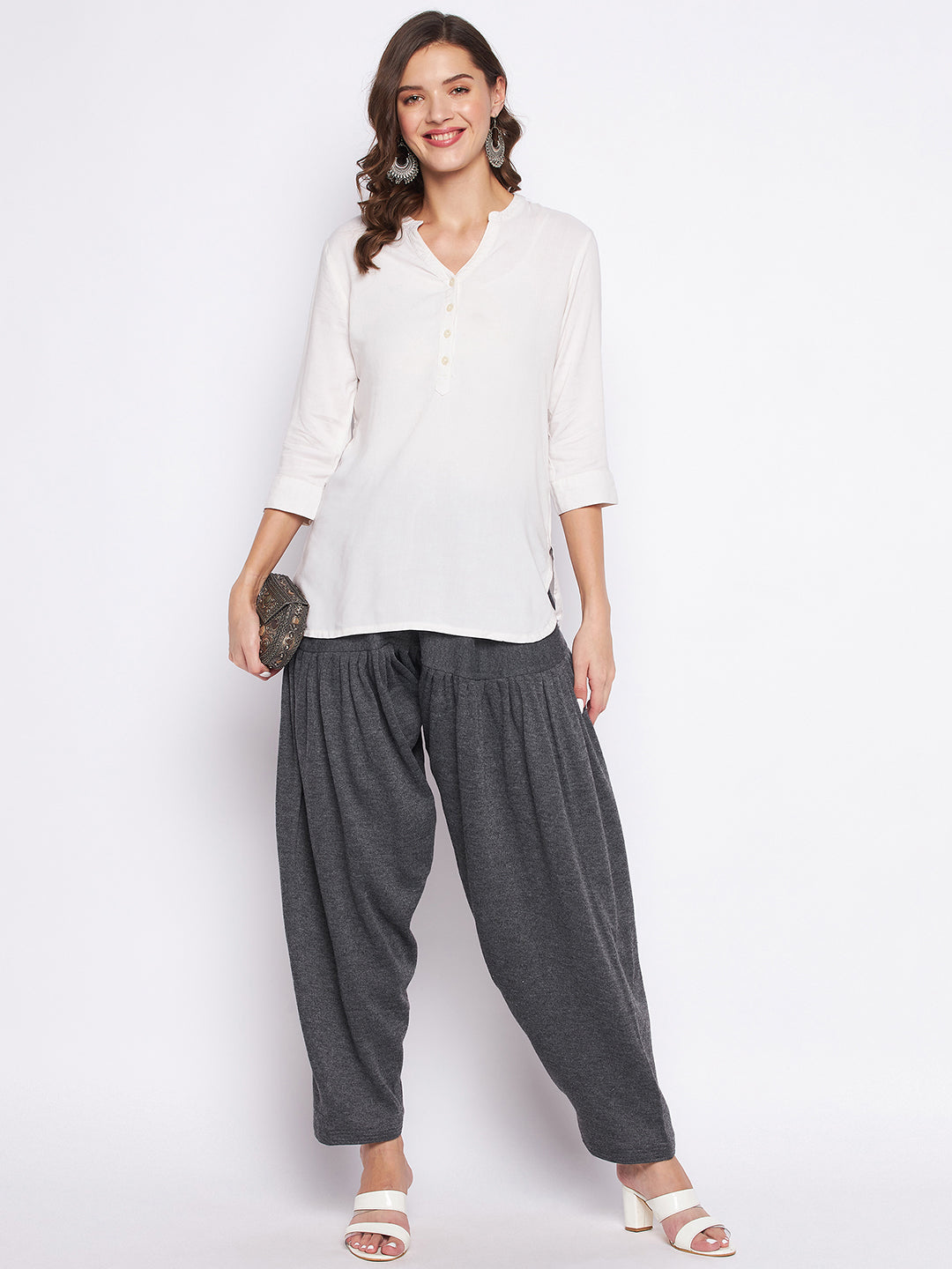 Dark grey solid woolen salwar worn by a woman paired with a white top.