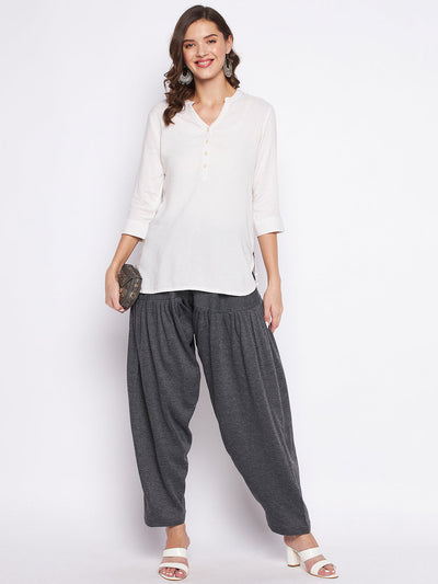 Dark grey solid woolen salwar worn by a woman paired with a white top.