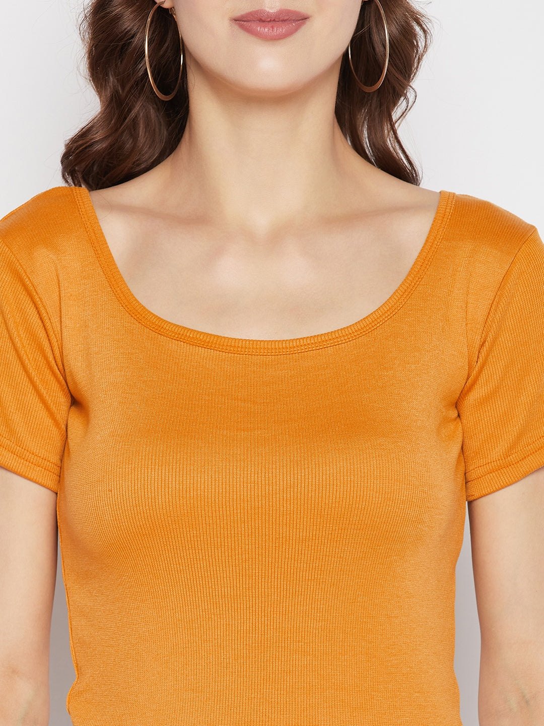 Mustard solid regular fit crop top with round neck and cap sleeves.