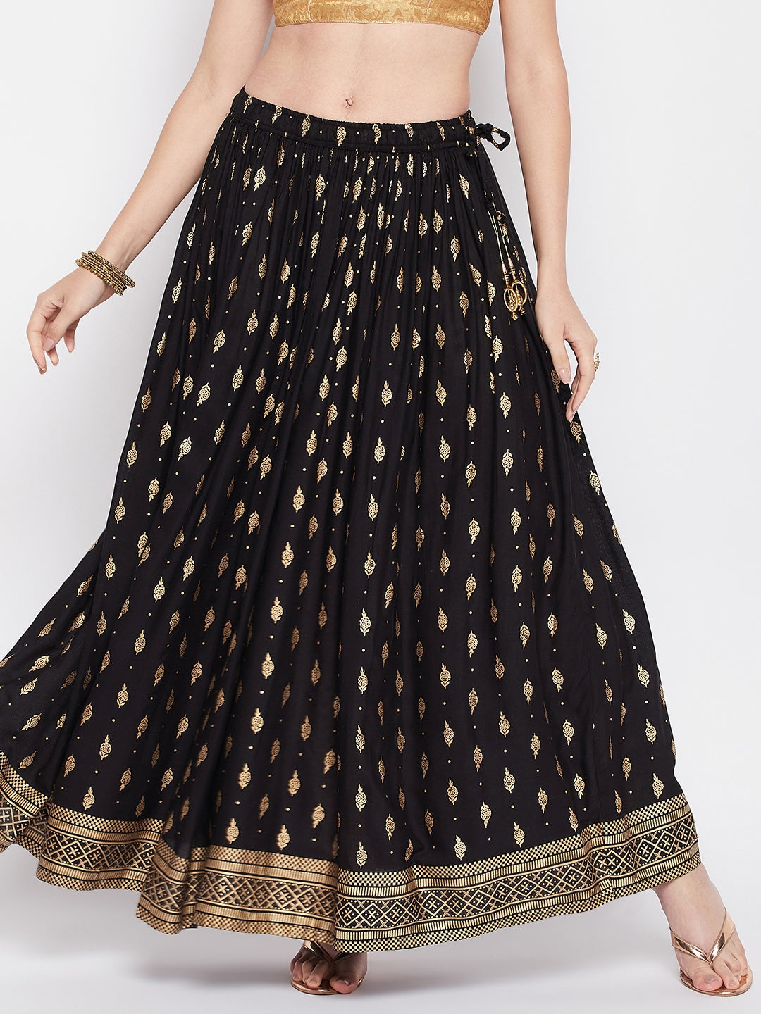 Black printed rayon maxi skirt with elastic waistband and flared hem.