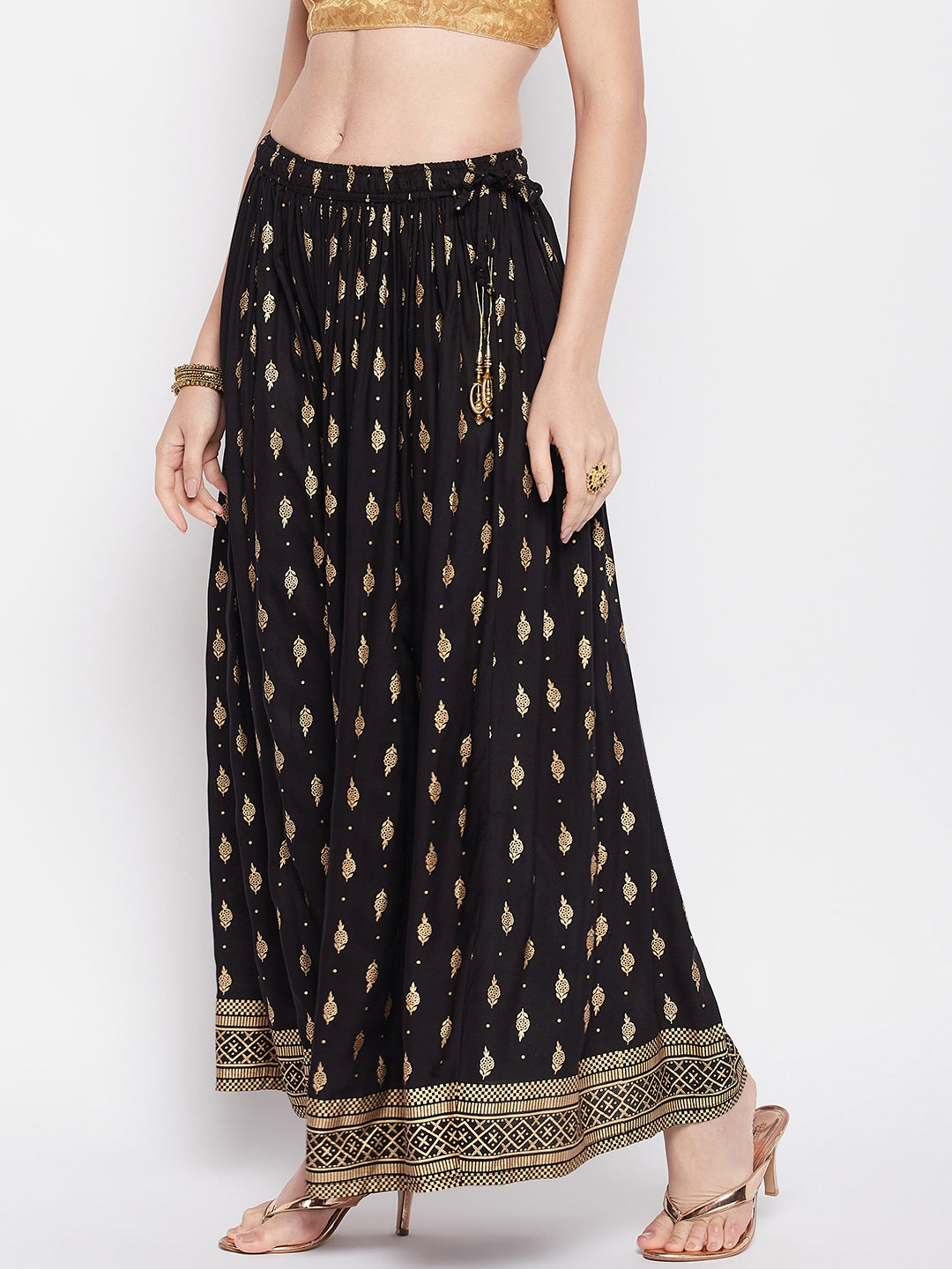 Black printed rayon maxi skirt with elasticated waistband and flared hem.