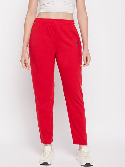 Red solid mid rise cotton track pants with elastic waistband and drawstring.