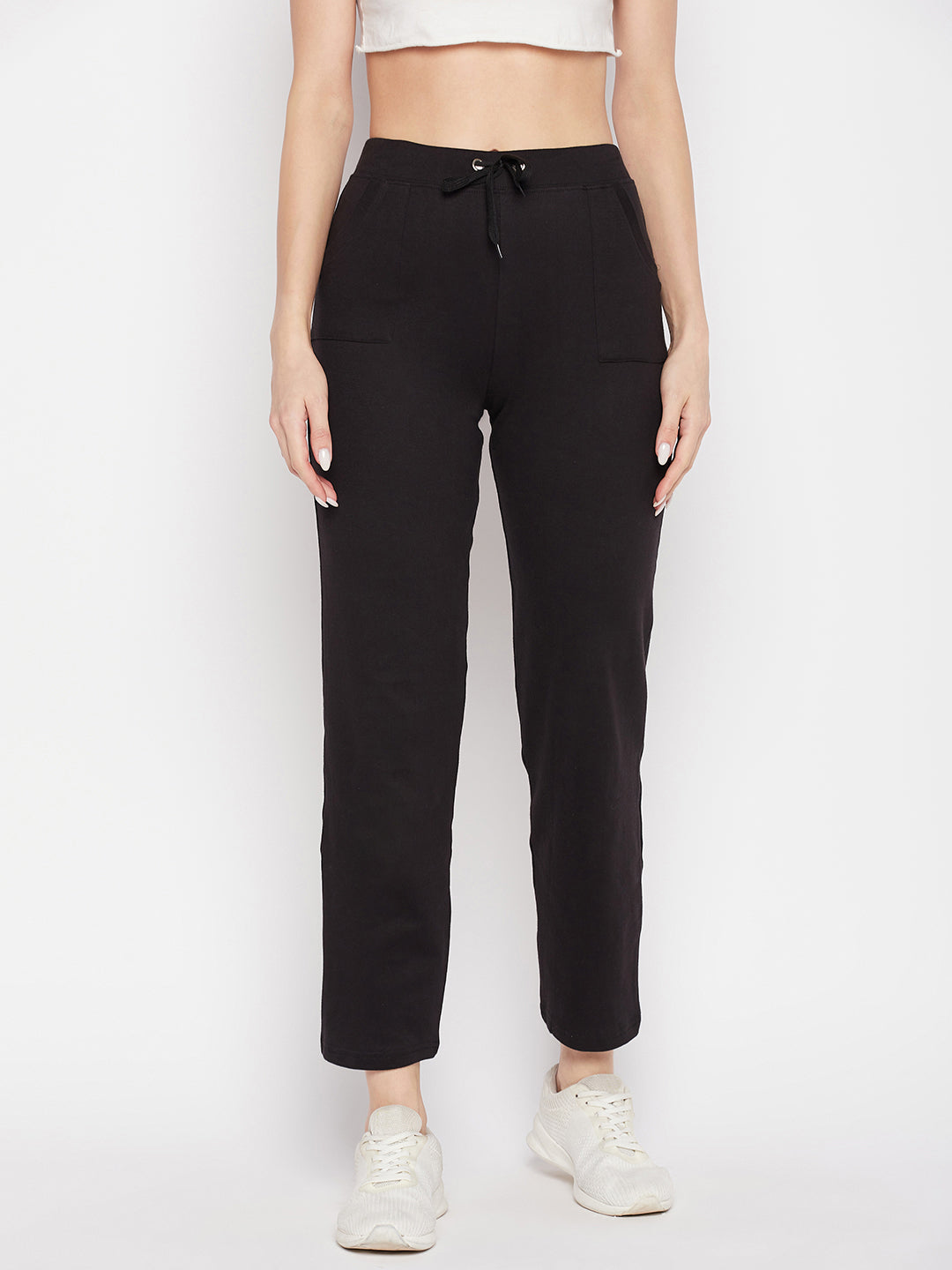 Black solid mid rise cotton trackpants with elasticated waistband and drawstring closure.