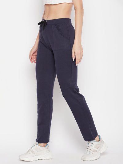 Navy blue solid mid rise cotton trackpants with elasticated waistband and drawstring closure.